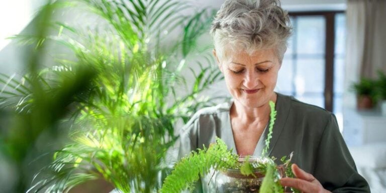 Elderly Woman Tending to Houseplants at Independent Living Facility